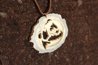 Intricately detailed roaring bear pendant hand crafted out of moose antler. The blade was attached and removed 14 times to finish this Bear Spirit pendant. Size: 2"x 2.5"